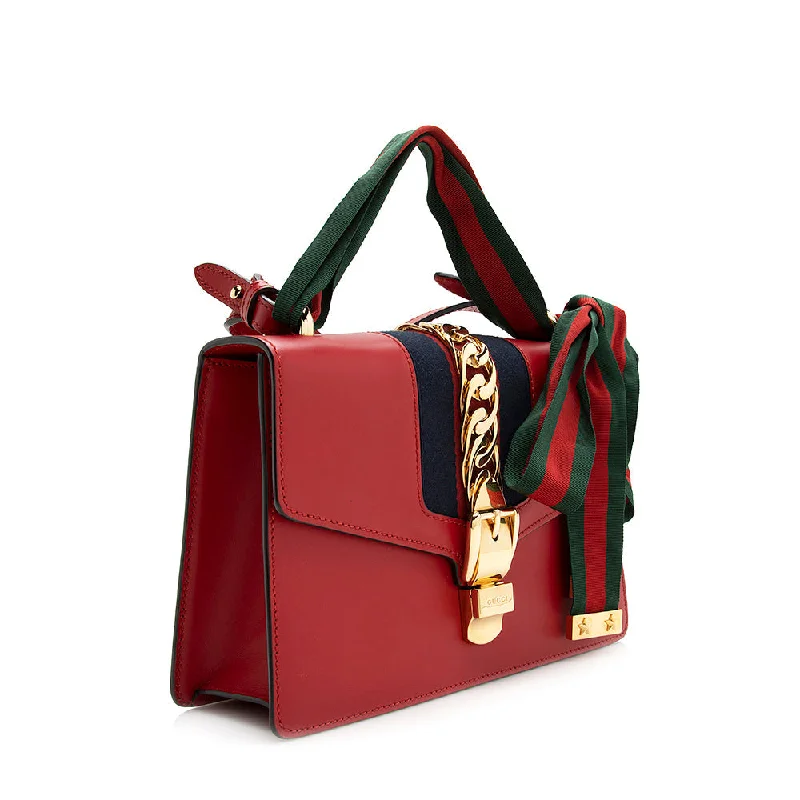 Women Gucci Sylvie bags featuring the signature web stripeGucci Calfskin Sylvie Small Shoulder Bag (21174)