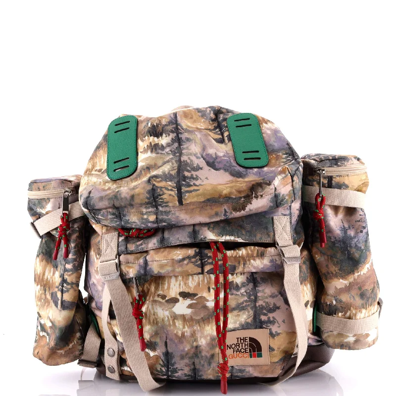 Women Gucci bags with a snap - button closure and a decorative charmGucci x The North Face Flap Backpack Printed Nylon Large