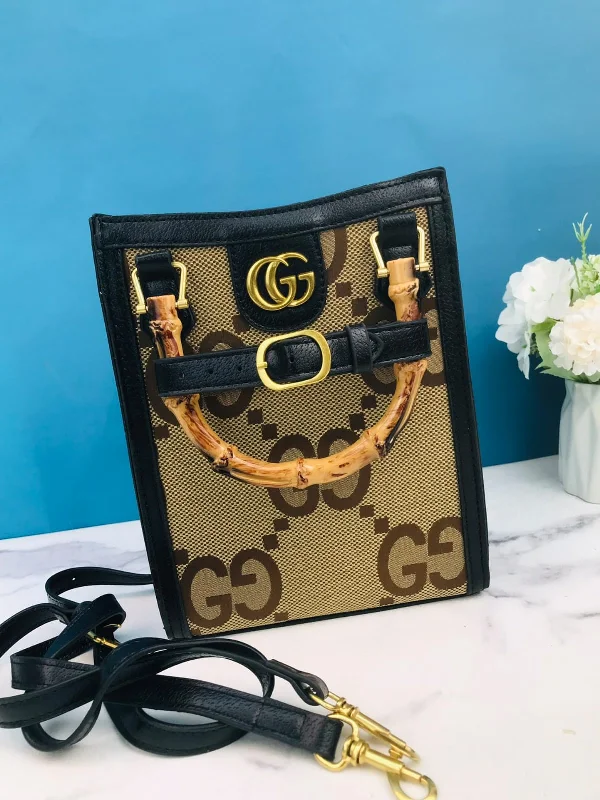 Women Gucci bags with a chain - link trim and a leather bodyGucci bamboo handle tote handbag